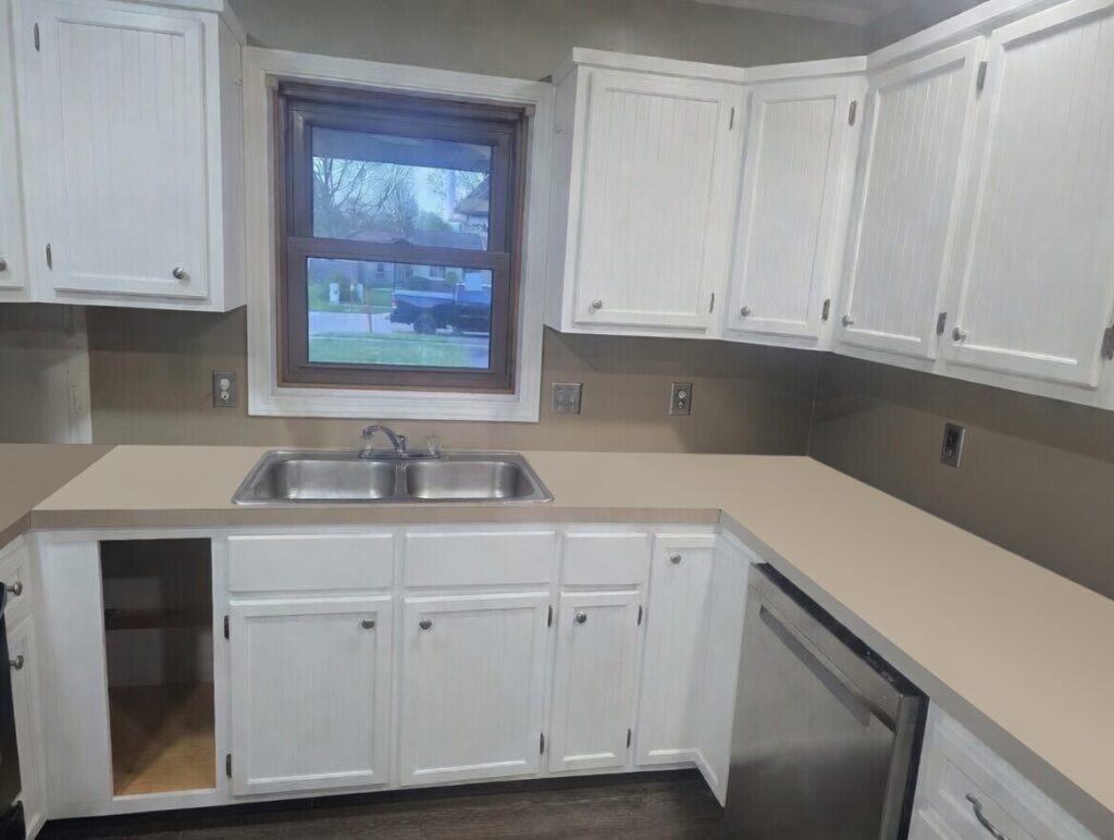 White-painted kitchen cabinets after refinishing in Cascade, MI by Frontjes Painting