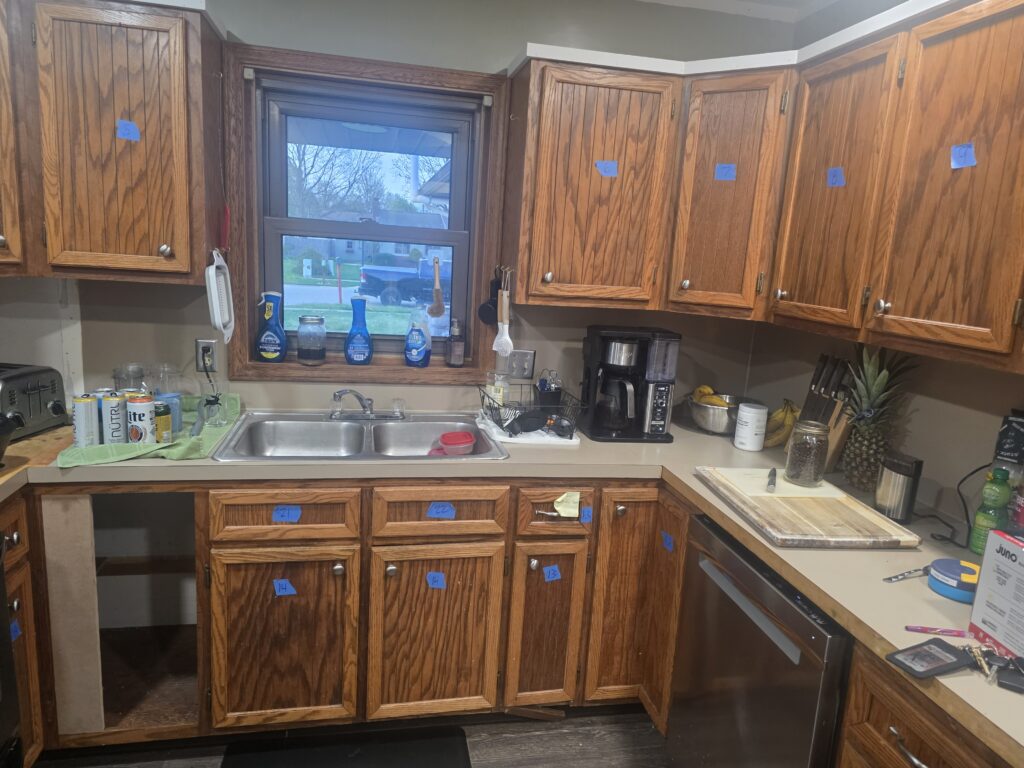 Honey-oak kitchen cabinets before painting in Cascade, MI