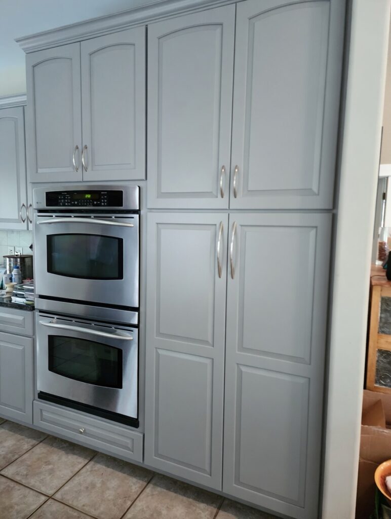 Gray kitchen cabinets after refinishing in Ada, MI by Frontjes Painting